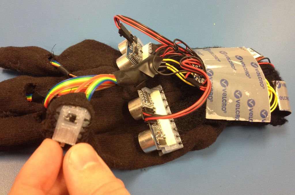 A Glove for the Blind to Feel Shapes and Navigate Obstacles